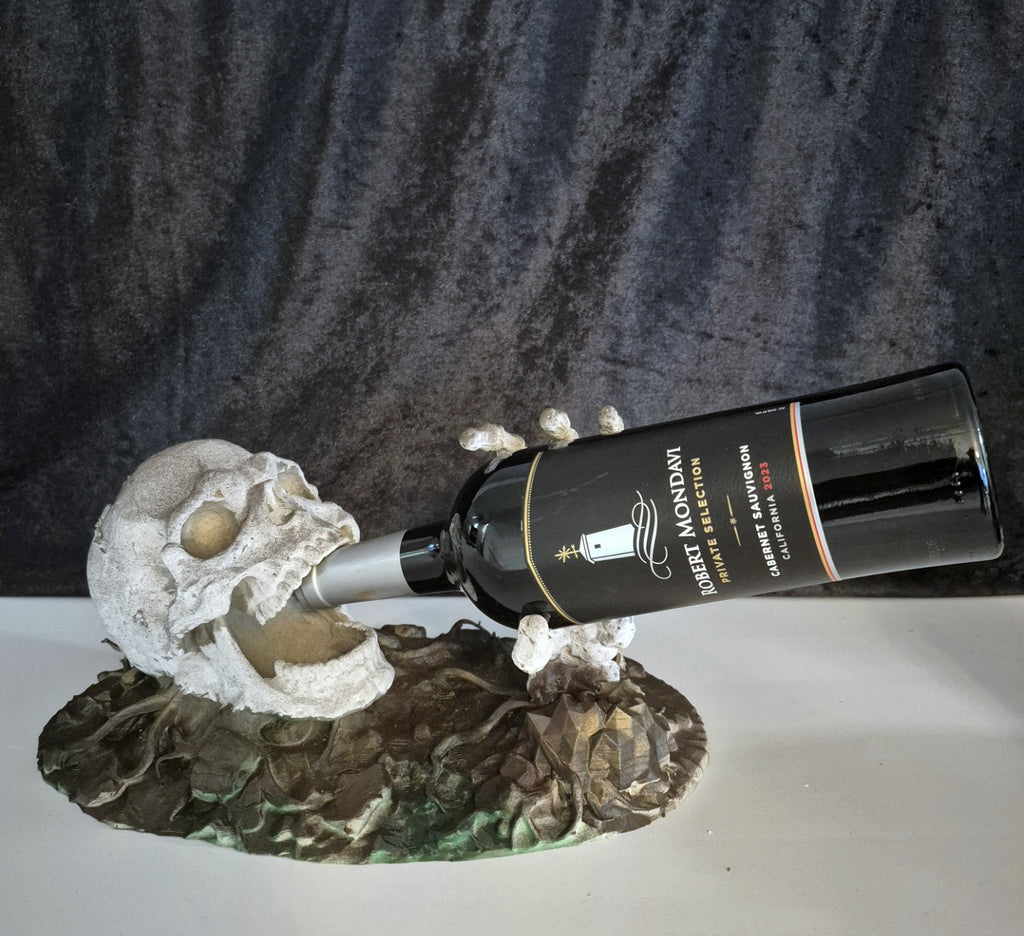Skeleton skull and hand bottle holder with wine bottle
